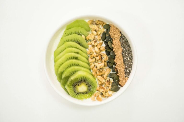 a smoothie bowl with fruit and nuts on top